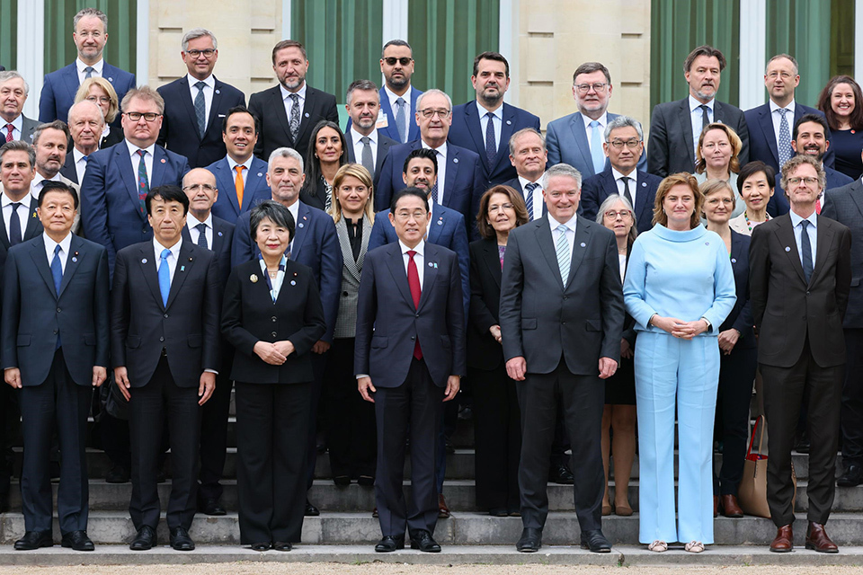 A group of OECD officials posing for a commemorative photo