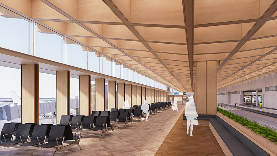 Interior image of a modern airport terminal with a row of black seating, large pillars, and windows allowing natural light to flood the space.