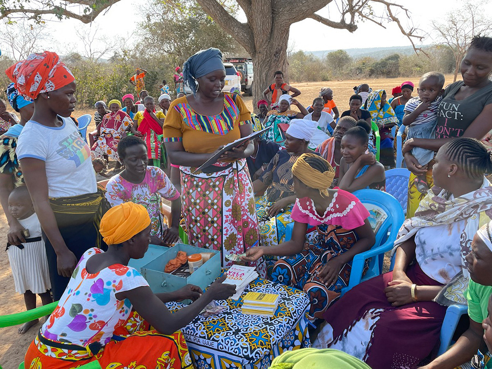 A group of mothers gathered around a small table in the center.