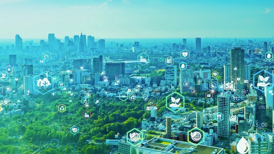 A cityscape of Tokyo with digital icons representing green technologies